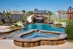 Luxury swimming pool with waterfall, home spa and slide