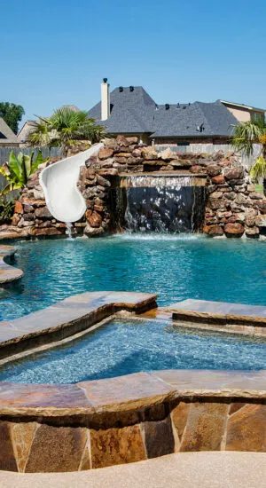 Luxury swimming pool with waterfall, home spa and slide