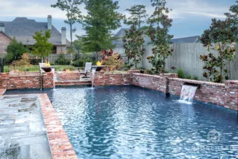 Swimming pool with fire bowls and water fountains