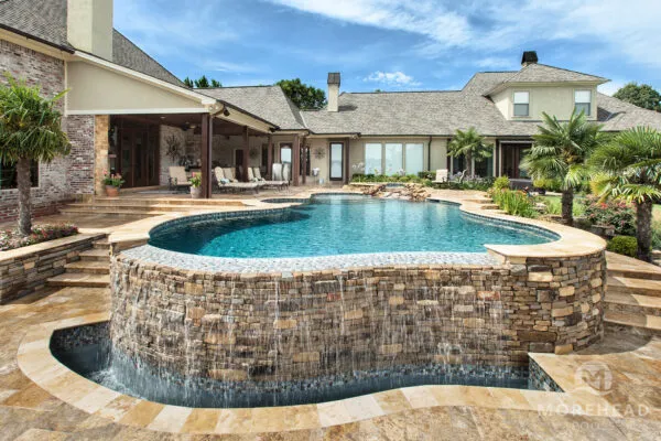 Luxury swimming pool with tanning ledge and water features