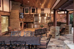 Sheltered outdoor kitchen with fireplace and eating area