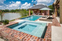 Geometric swimming pool with custom home spa