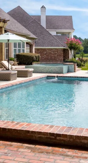 Geometric swimming pool with tanning ledge
