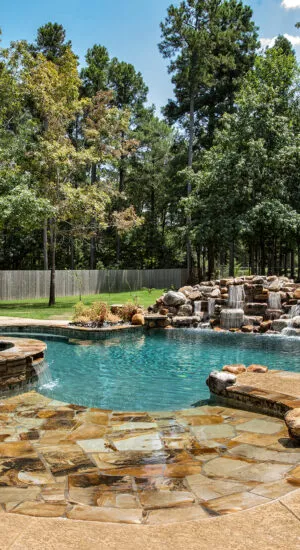 Luxury swimming pool with rock waterfall, tanning ledge and custom spa