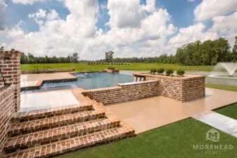 Luxury geometric swimming pool with spa and laminar deck jet