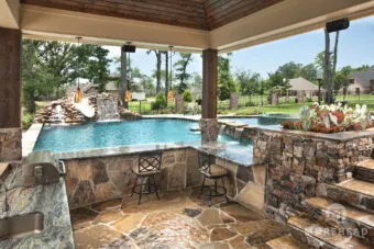 Outdoor kitchen with swim up pool bar