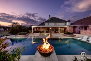 Lit fire feature for swimming pools